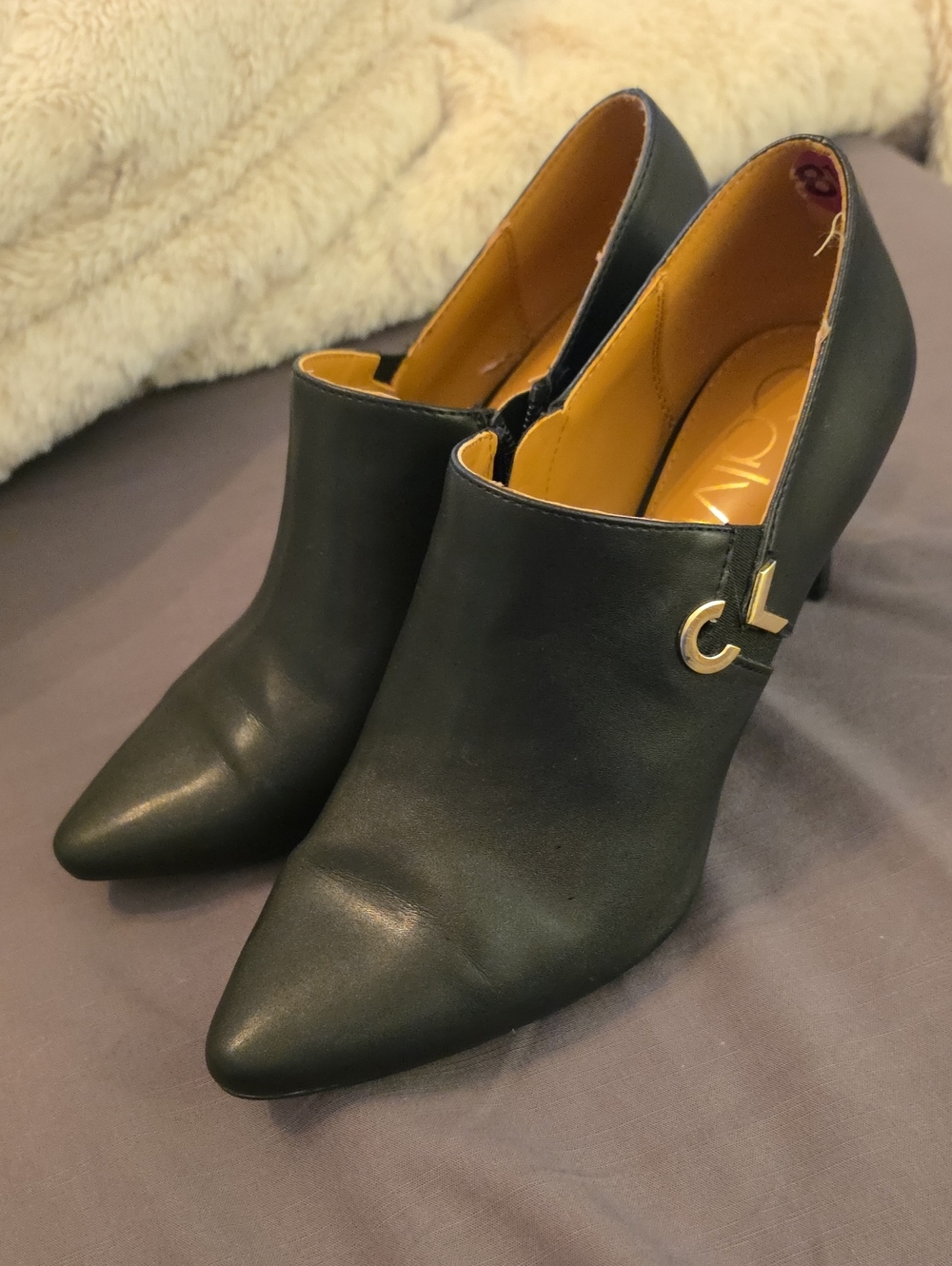 Calvin Klein Black Pointed-Heel Booties with Gold CK Accent